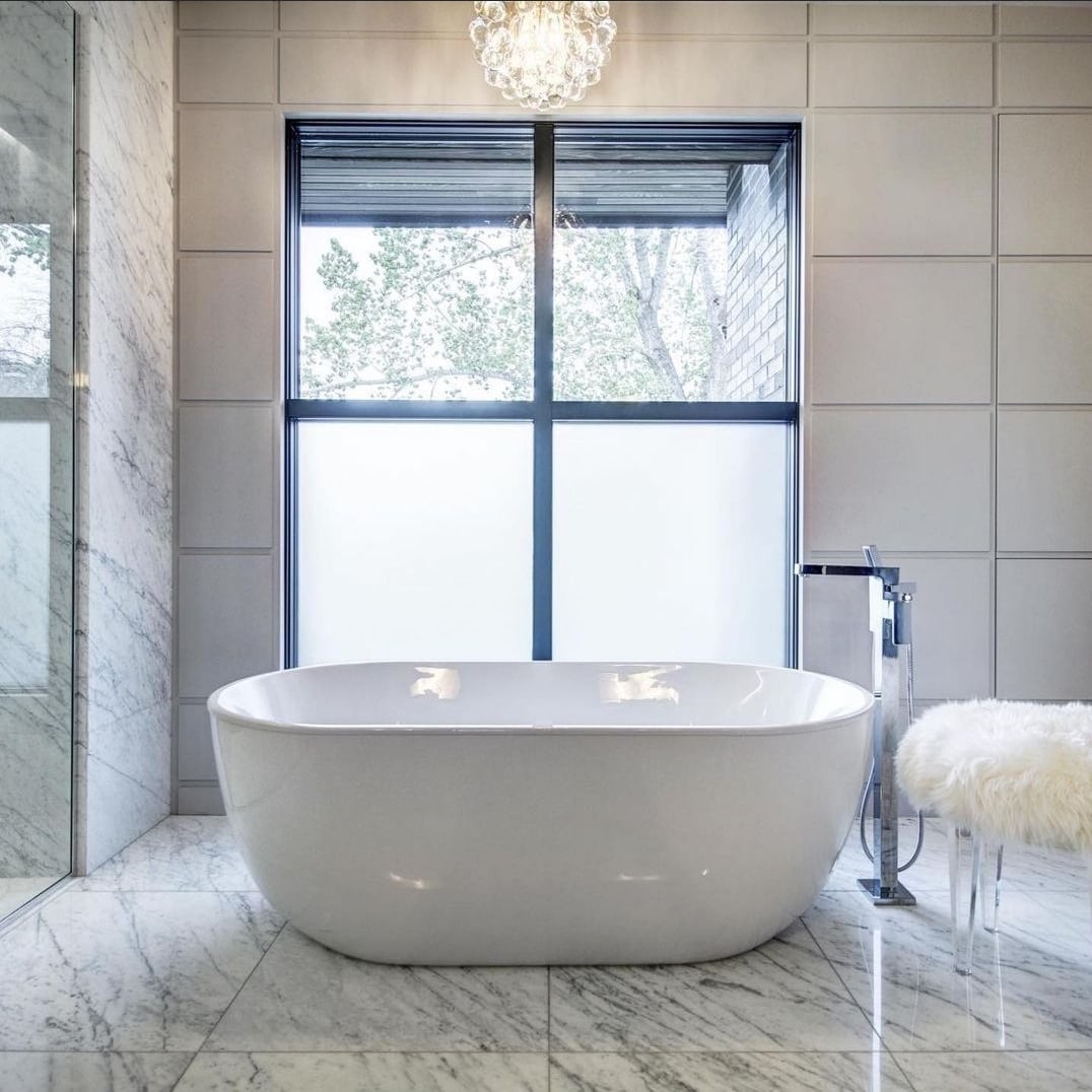 white bath tub on marble floor